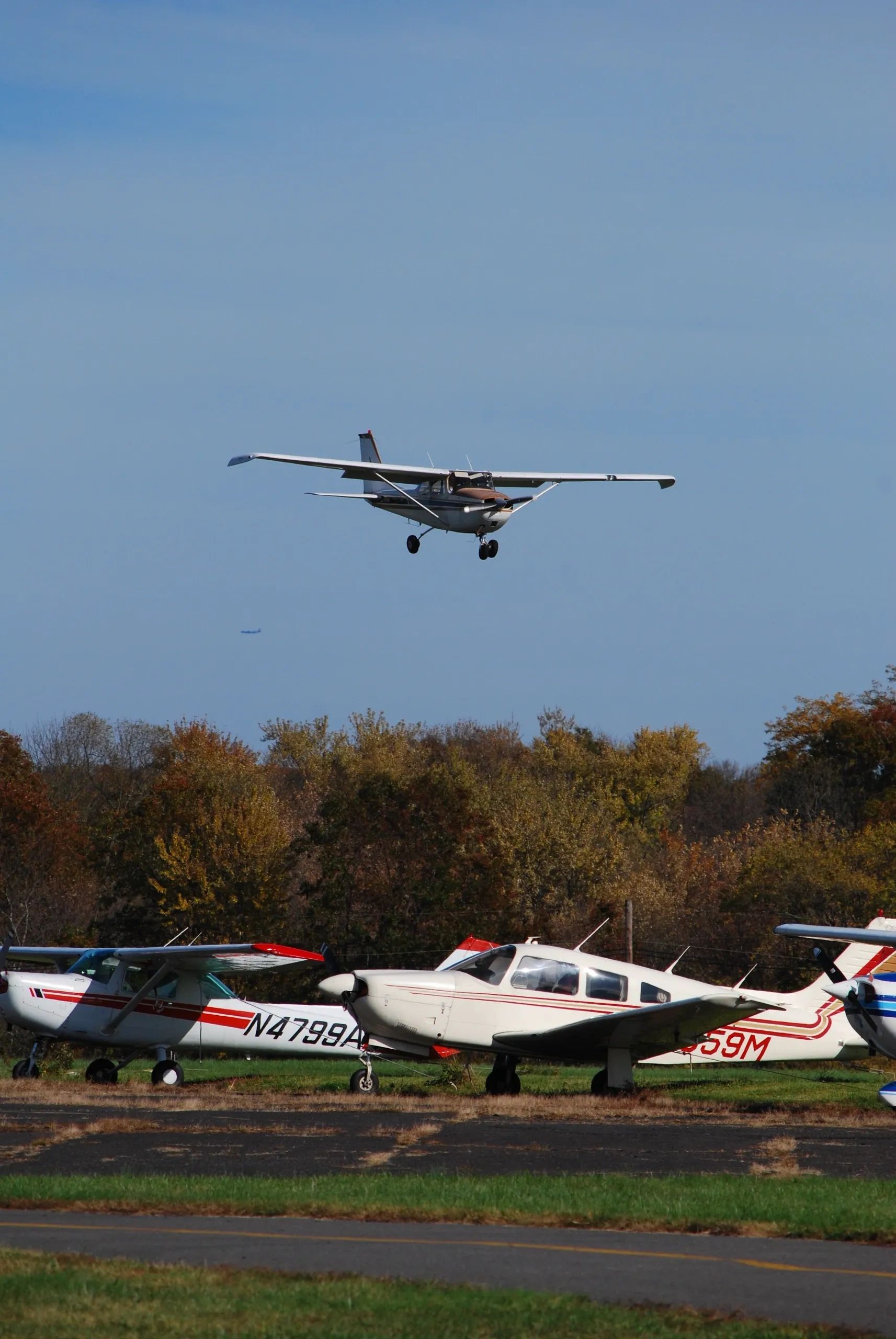 Light aircraft in flight near an airfield